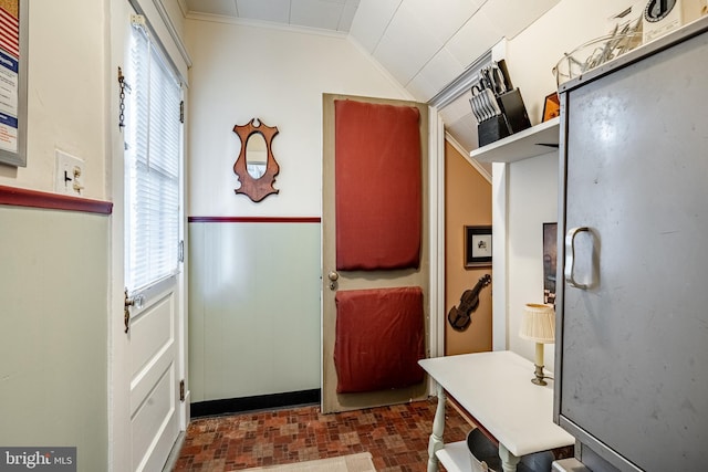 kitchen featuring crown molding and vaulted ceiling