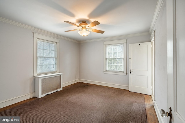 unfurnished bedroom featuring radiator, a ceiling fan, crown molding, and baseboards