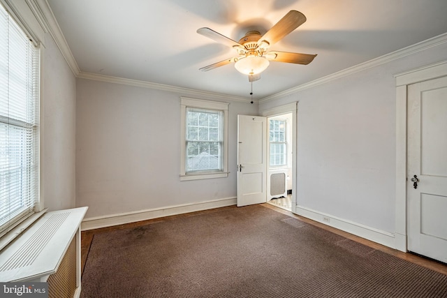 spare room featuring ceiling fan, baseboards, and ornamental molding