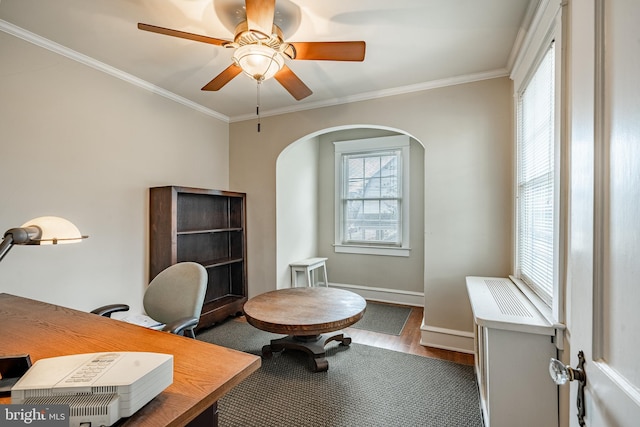 home office featuring ceiling fan, wood finished floors, baseboards, and ornamental molding