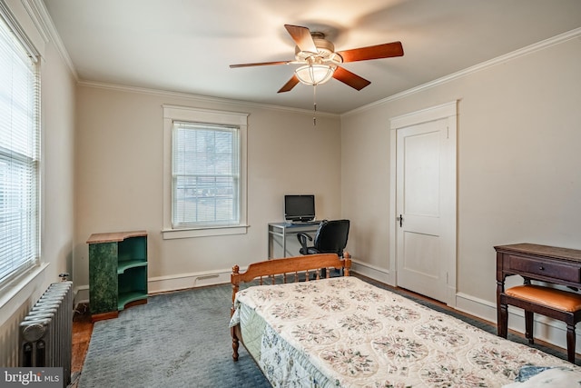 bedroom featuring baseboards, multiple windows, radiator, and crown molding