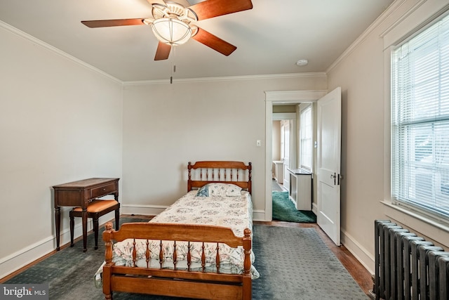 bedroom with radiator, crown molding, and baseboards