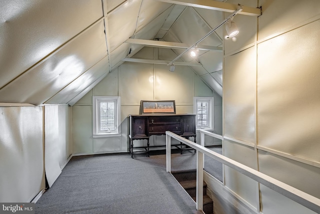 additional living space with lofted ceiling with beams, carpet, and a wealth of natural light