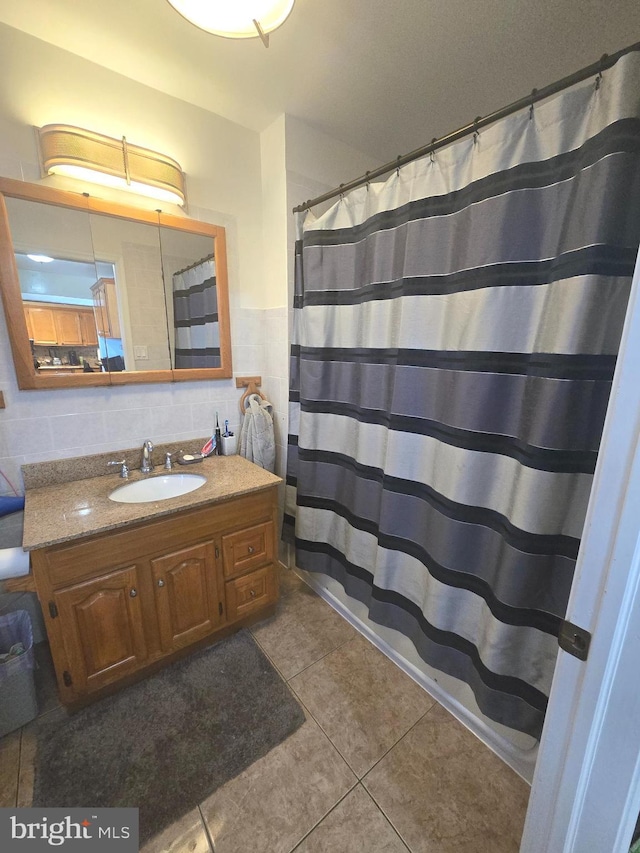 bathroom featuring a shower with shower curtain, tile patterned floors, tile walls, and vanity