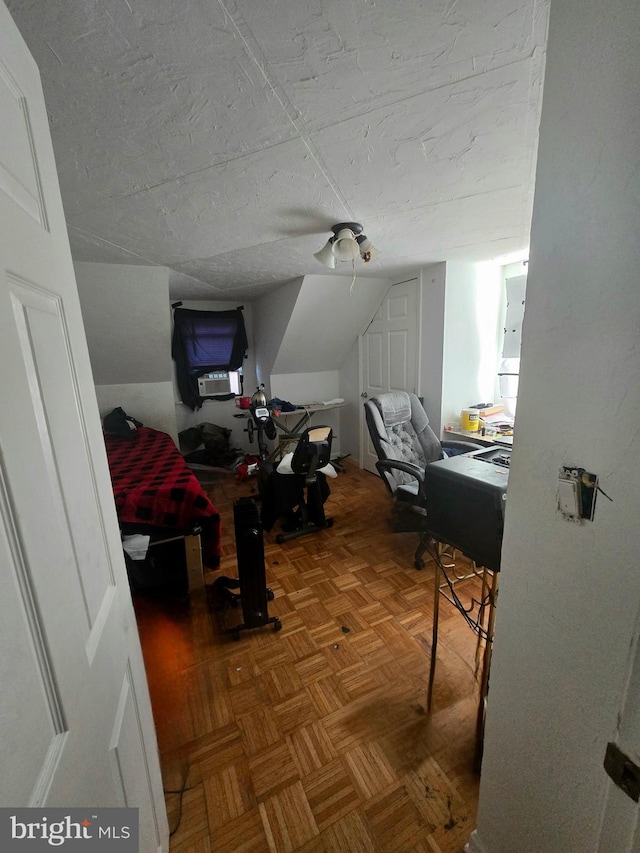 office with lofted ceiling and a textured ceiling