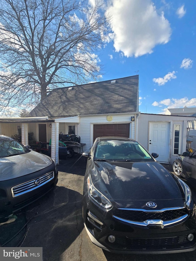 view of side of home featuring an attached garage