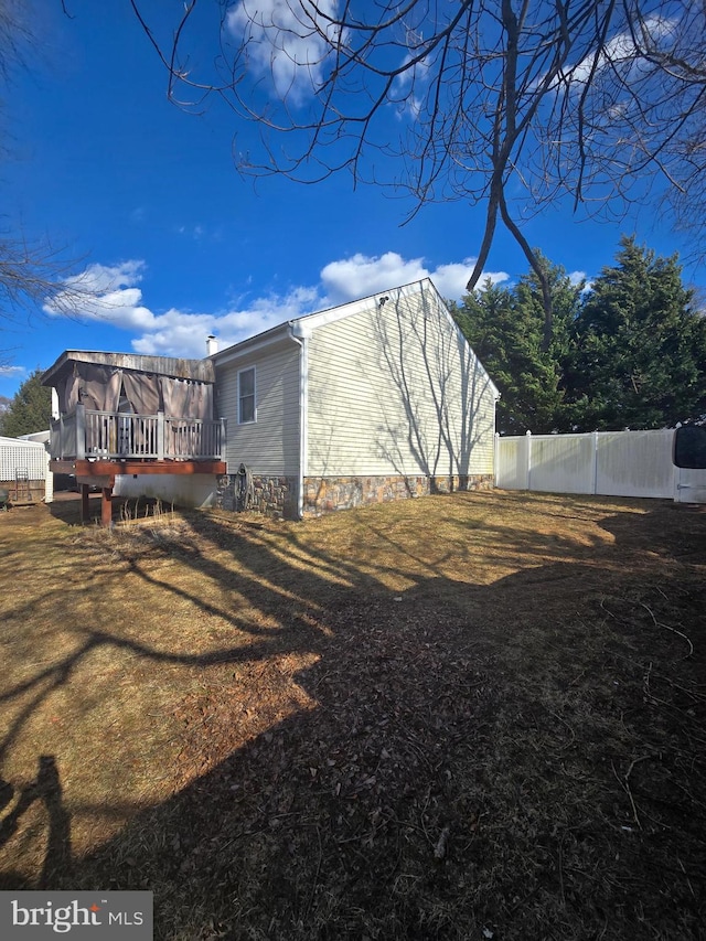 exterior space featuring fence and a deck