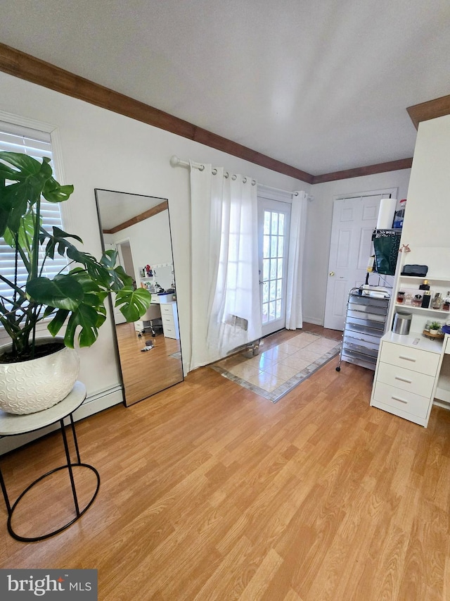 interior space featuring light wood-style flooring and crown molding