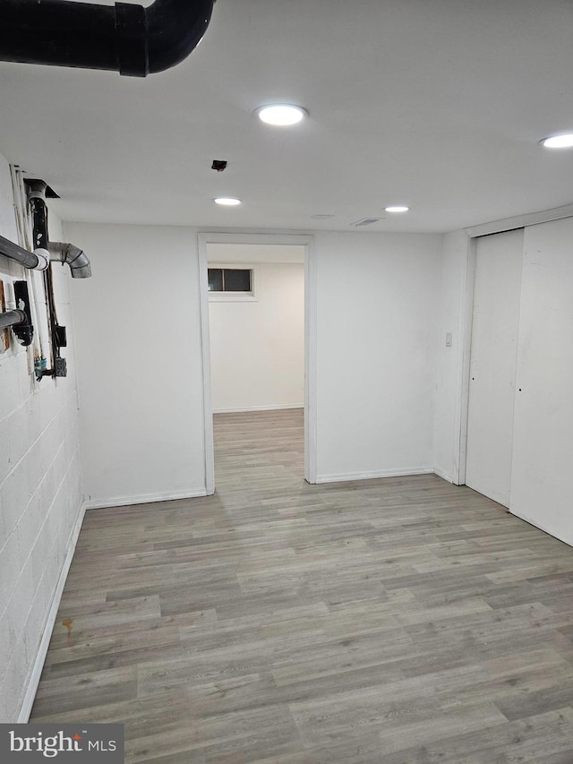 finished basement featuring recessed lighting, baseboards, and wood finished floors