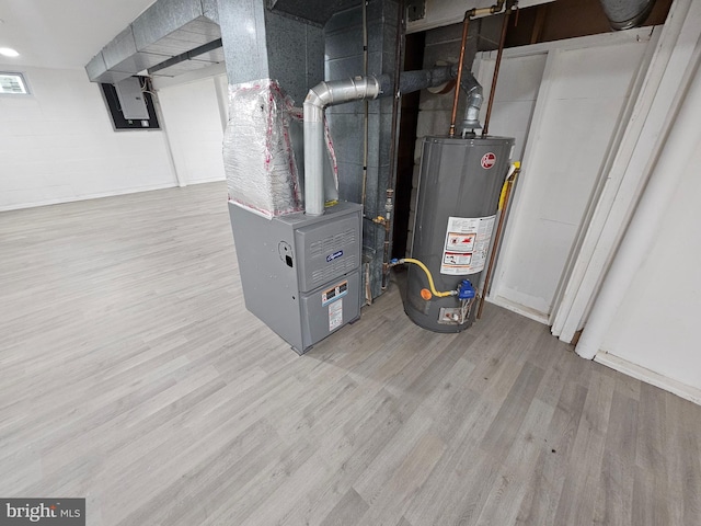 utility room with gas water heater, electric panel, and heating unit