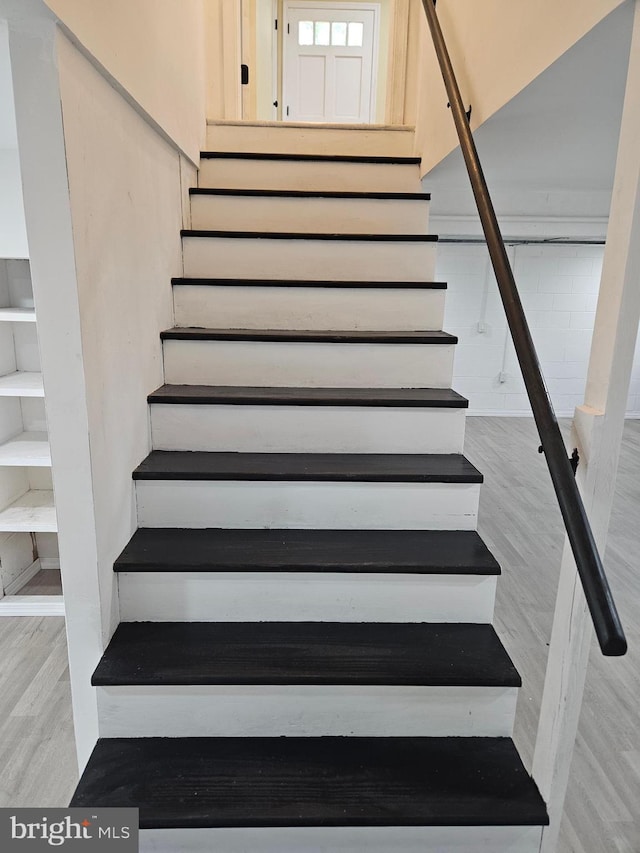 staircase featuring wood finished floors