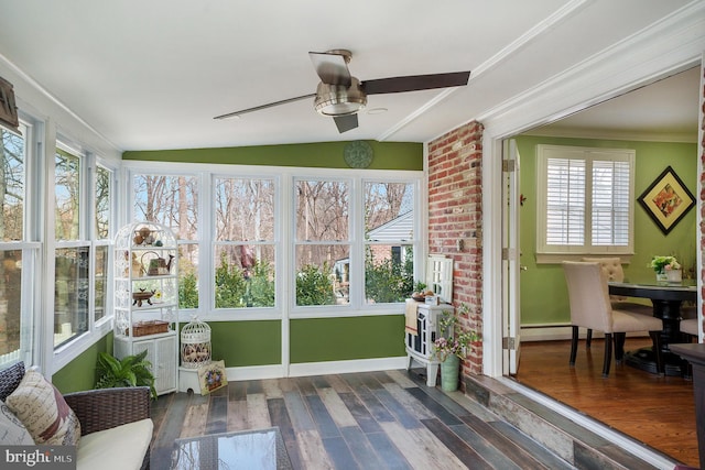 sunroom / solarium featuring ceiling fan and vaulted ceiling