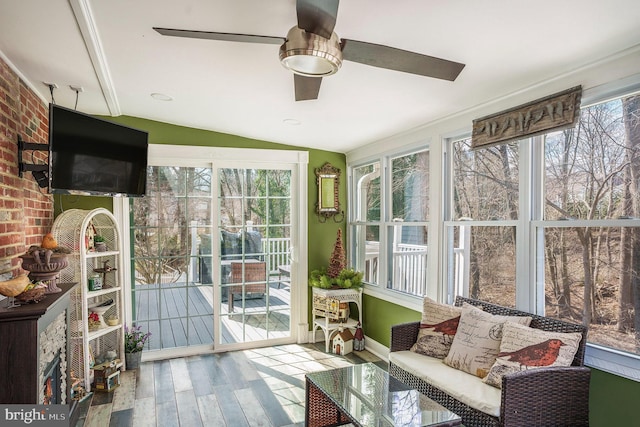 sunroom / solarium with lofted ceiling and ceiling fan