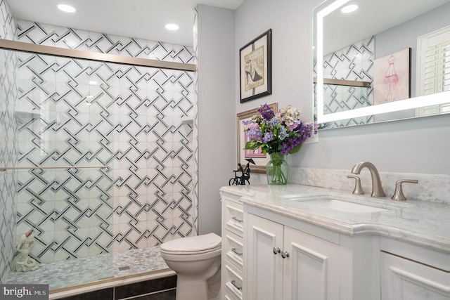 full bath with recessed lighting, a shower stall, toilet, and vanity