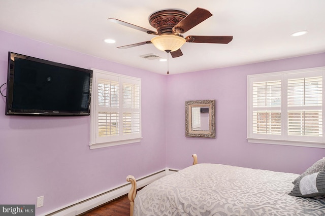 bedroom with recessed lighting, visible vents, multiple windows, and baseboard heating