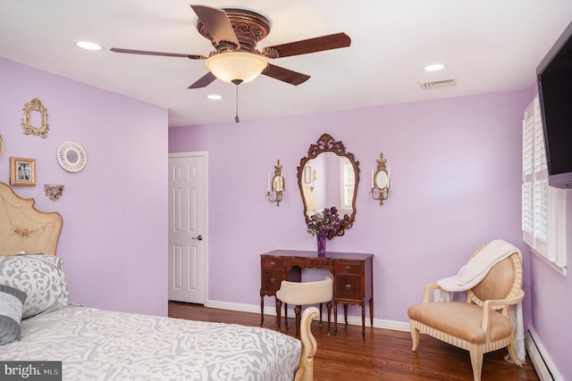 bedroom with wood finished floors, baseboards, visible vents, a baseboard radiator, and recessed lighting