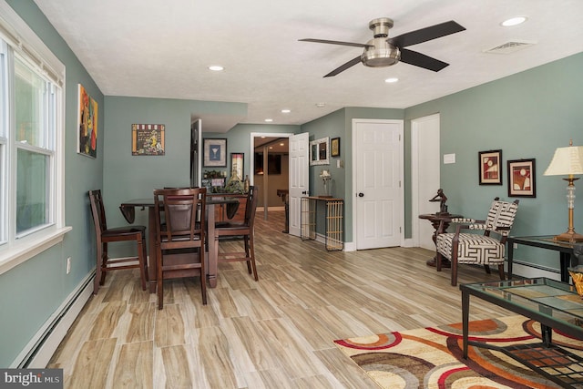 dining space with baseboards, visible vents, a baseboard radiator, light wood-style flooring, and recessed lighting