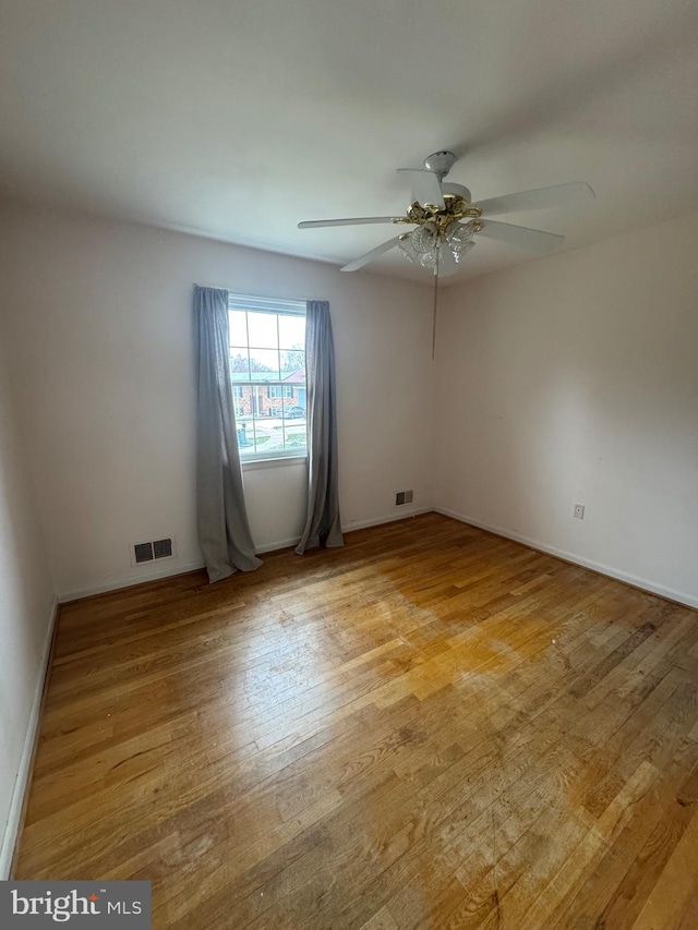 unfurnished room featuring visible vents, ceiling fan, baseboards, and light wood-style floors