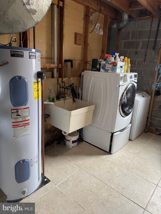 laundry area with a sink, laundry area, water heater, and washer and dryer