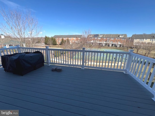 wooden terrace with a residential view and area for grilling