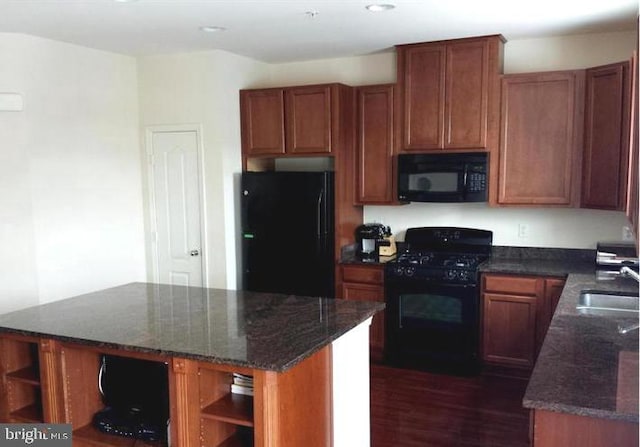 kitchen with open shelves, a sink, a center island, black appliances, and dark stone countertops