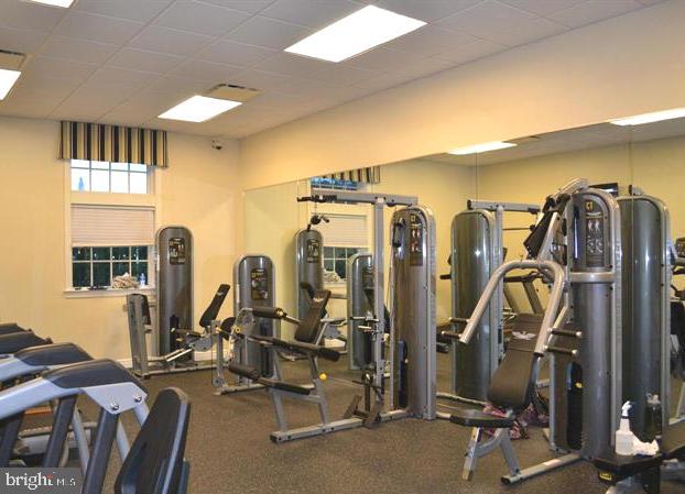 gym featuring a paneled ceiling