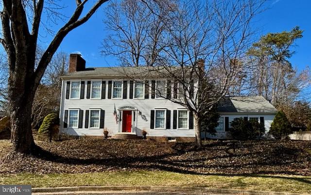 colonial home featuring a chimney
