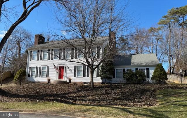 colonial house featuring a chimney