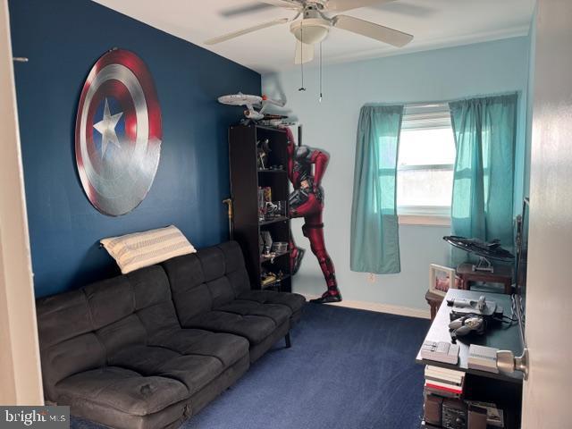 interior space with ceiling fan and carpet