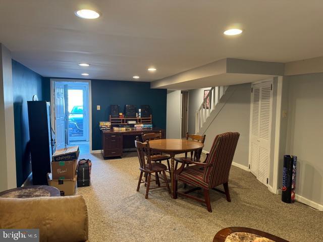 dining room featuring recessed lighting, stairway, and light carpet