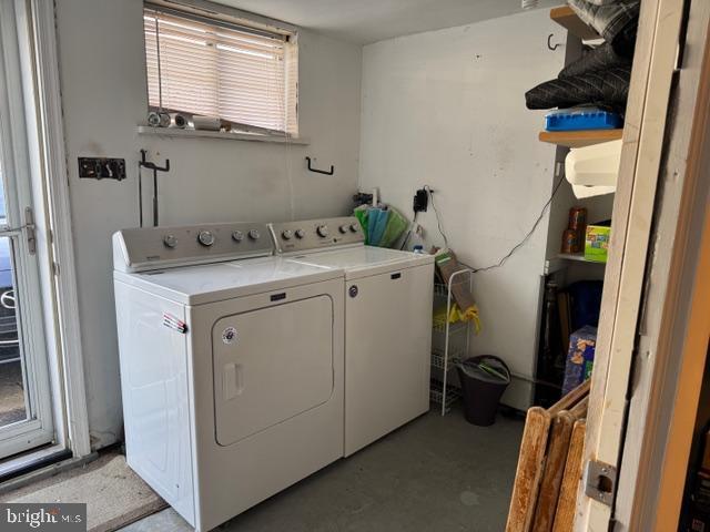 clothes washing area featuring washer and dryer and laundry area