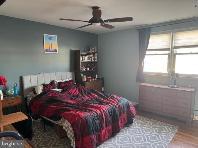 bedroom with wood finished floors and a ceiling fan