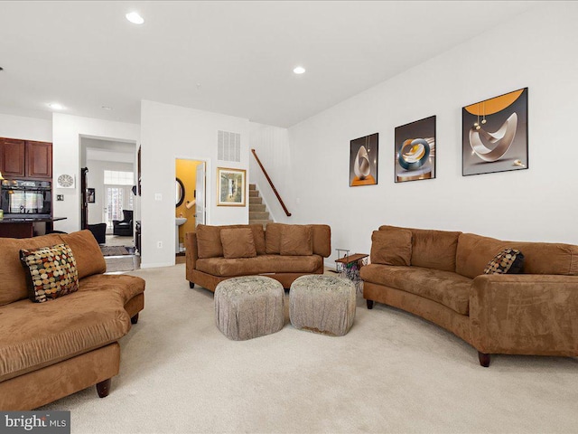 living room featuring stairs, recessed lighting, light colored carpet, and visible vents