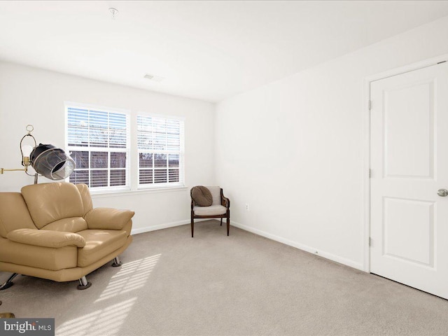 sitting room with carpet flooring, visible vents, and baseboards