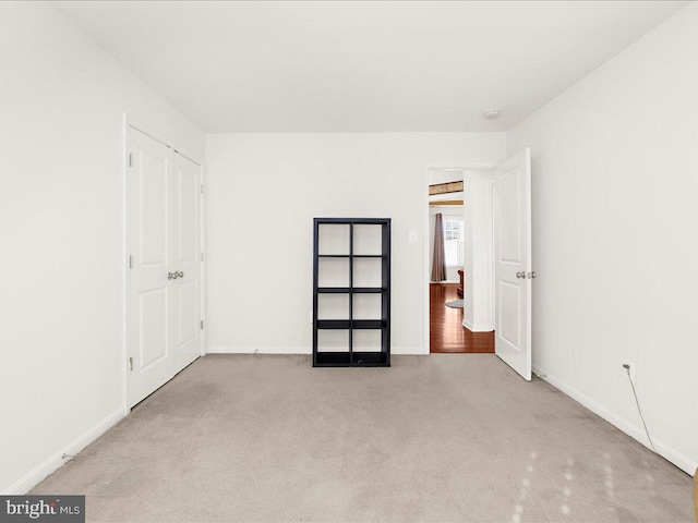 unfurnished bedroom with baseboards and carpet floors