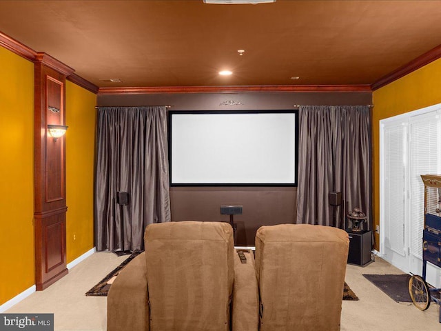 home theater featuring light carpet, crown molding, and baseboards