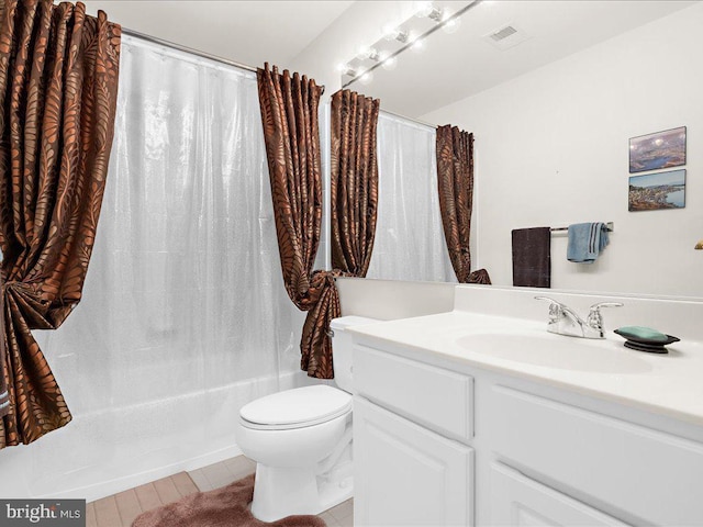 bathroom featuring vanity, shower / tub combo, toilet, and visible vents