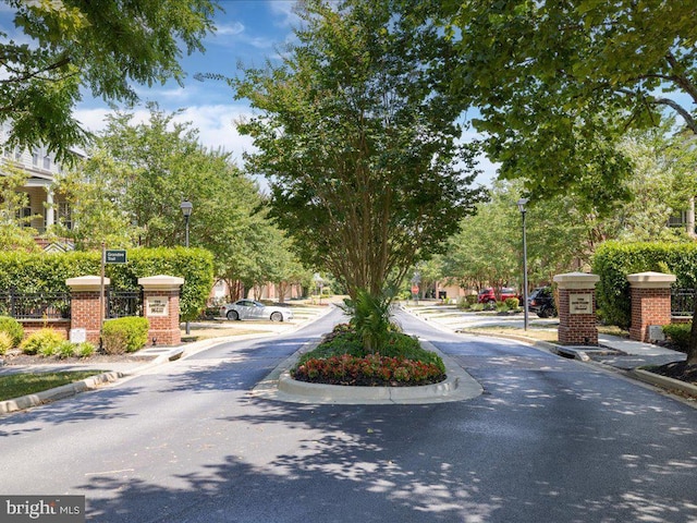 view of road featuring curbs, street lights, and sidewalks