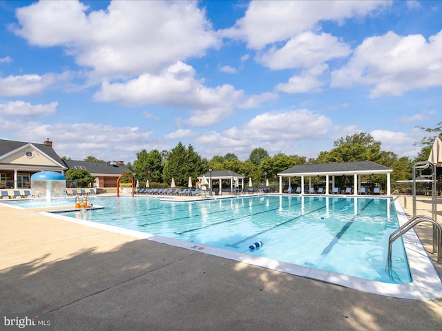 community pool with a gazebo and a patio area