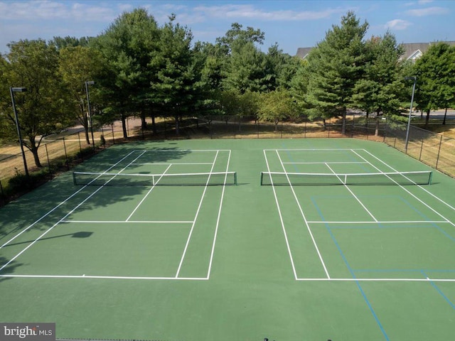 view of tennis court with fence