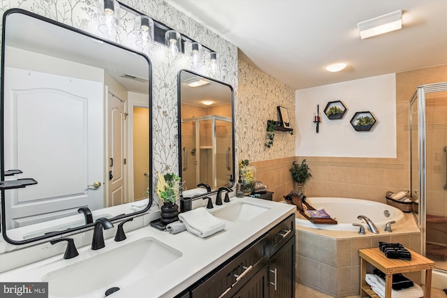 full bathroom featuring visible vents, wallpapered walls, a stall shower, a sink, and a garden tub