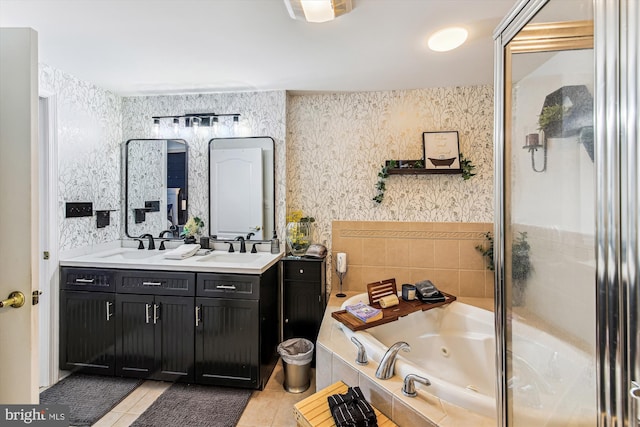 full bath featuring tile patterned floors, a tub with jets, wallpapered walls, and a sink