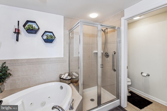 full bathroom with tile patterned flooring, a tub with jets, a shower stall, and toilet