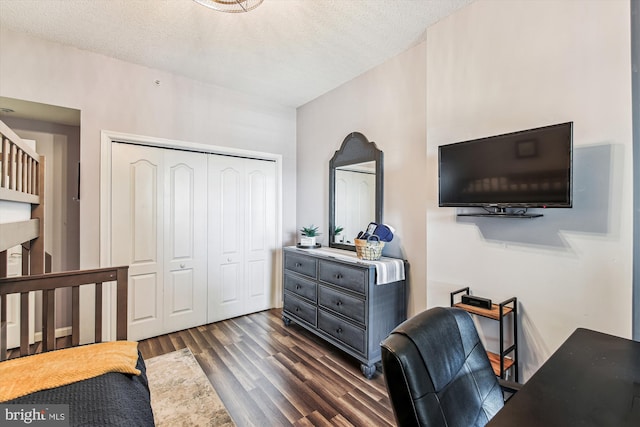 bedroom featuring a closet, a textured ceiling, and wood finished floors