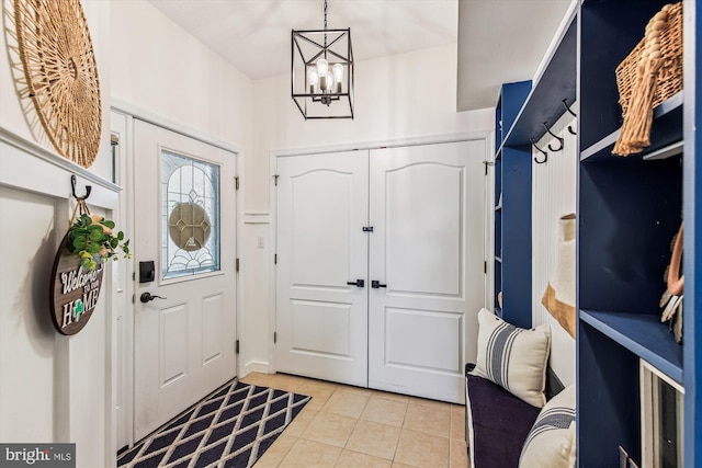 entrance foyer featuring light tile patterned floors and an inviting chandelier