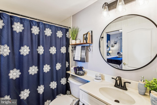 bathroom featuring vanity, toilet, and a shower with curtain