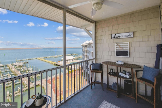 balcony featuring a water view and ceiling fan