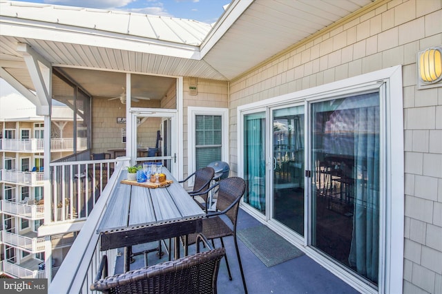 view of patio with outdoor dining space and a ceiling fan