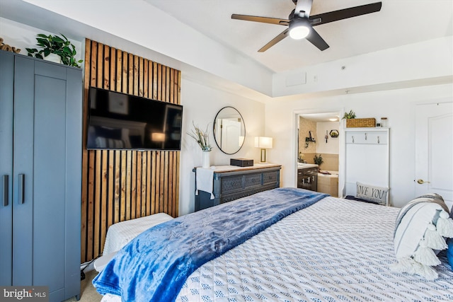 bedroom with ensuite bathroom and a ceiling fan