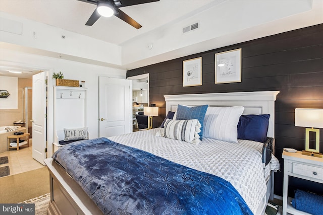 tiled bedroom with visible vents, wooden walls, and a ceiling fan